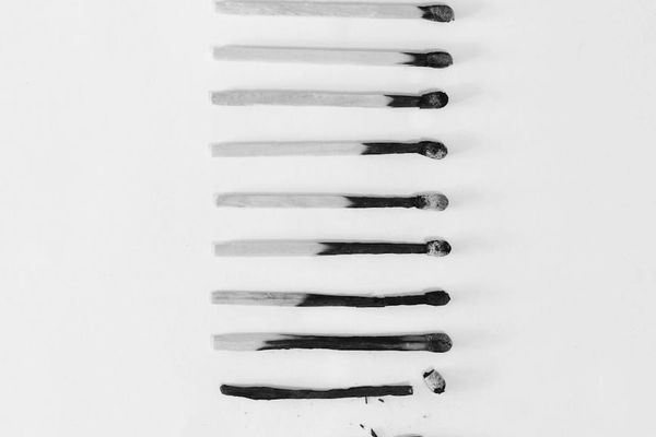 A sequence of images showing a man progressing through an exercise with focus.